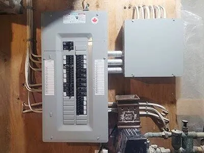 Residential electrical panel and service equipment installed inside a utility area.